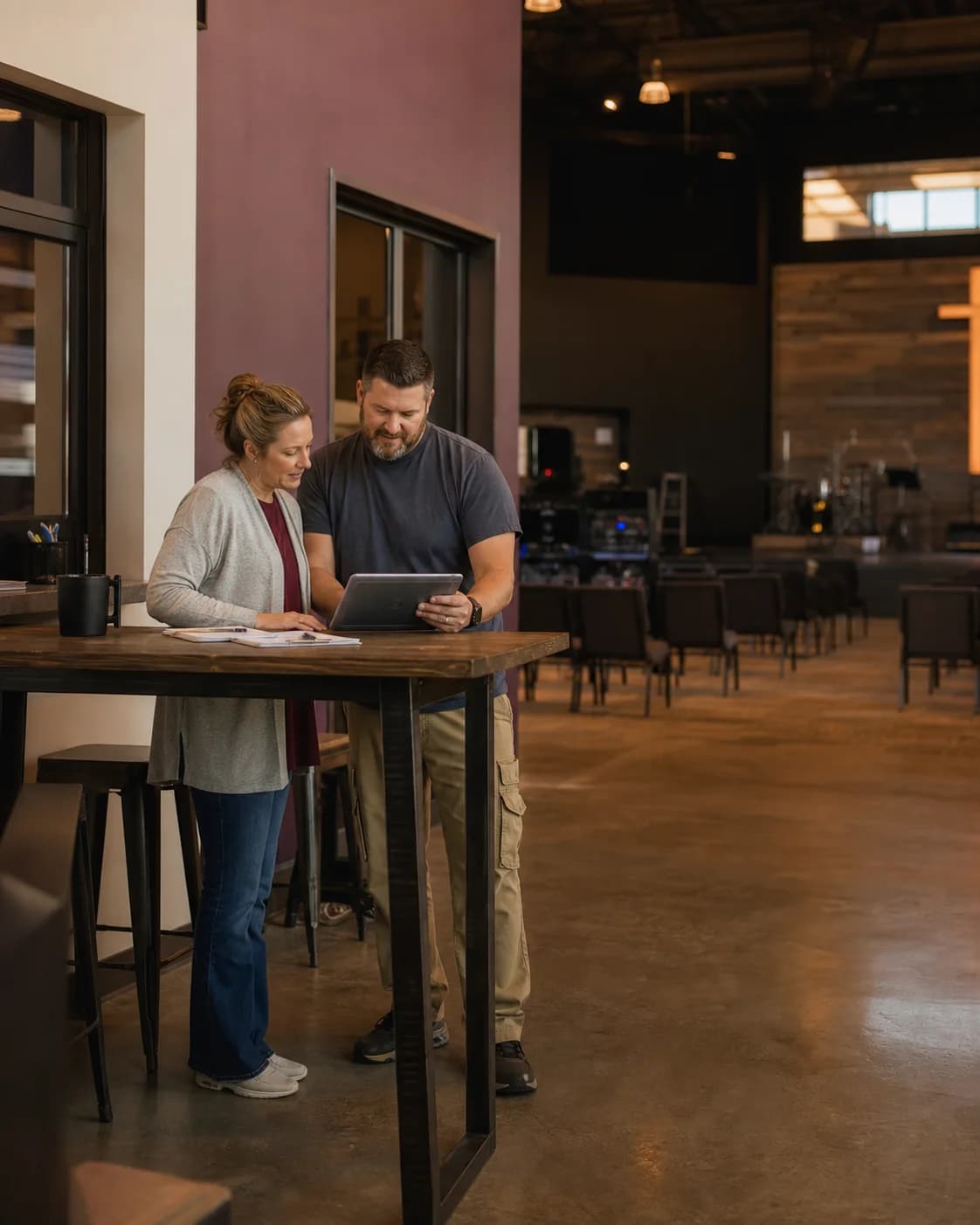 Two paid church staff coworkers review a weekly schedule in a church office